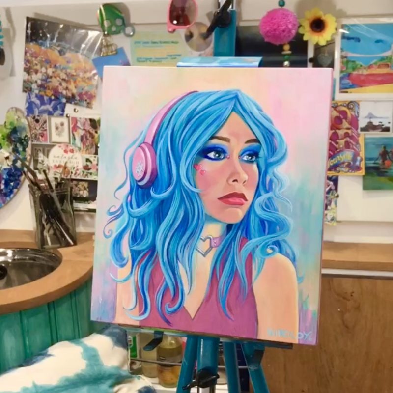 Colourful Oil Painting of a woman wearing headphones displayed on an easel in the artist studio