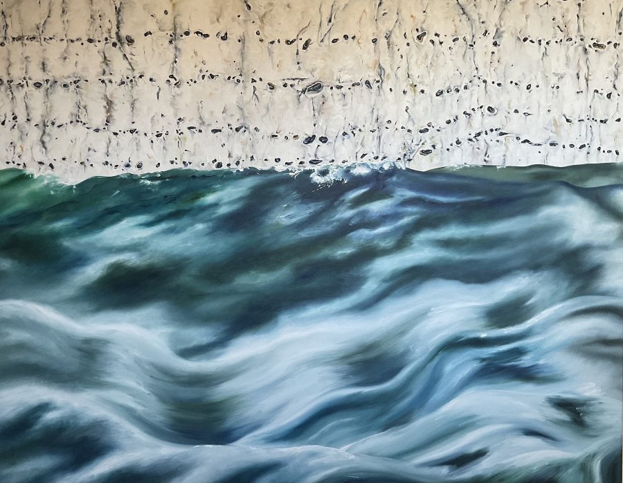 A seascape, the sea rolling along a detailed image of a flinty chalk cliff