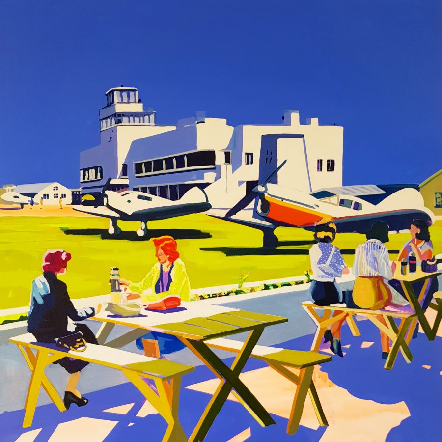 An image of Shoreham airport in bright colours with strong contrast. Beside the airport people enjoy sandwiches on benches  