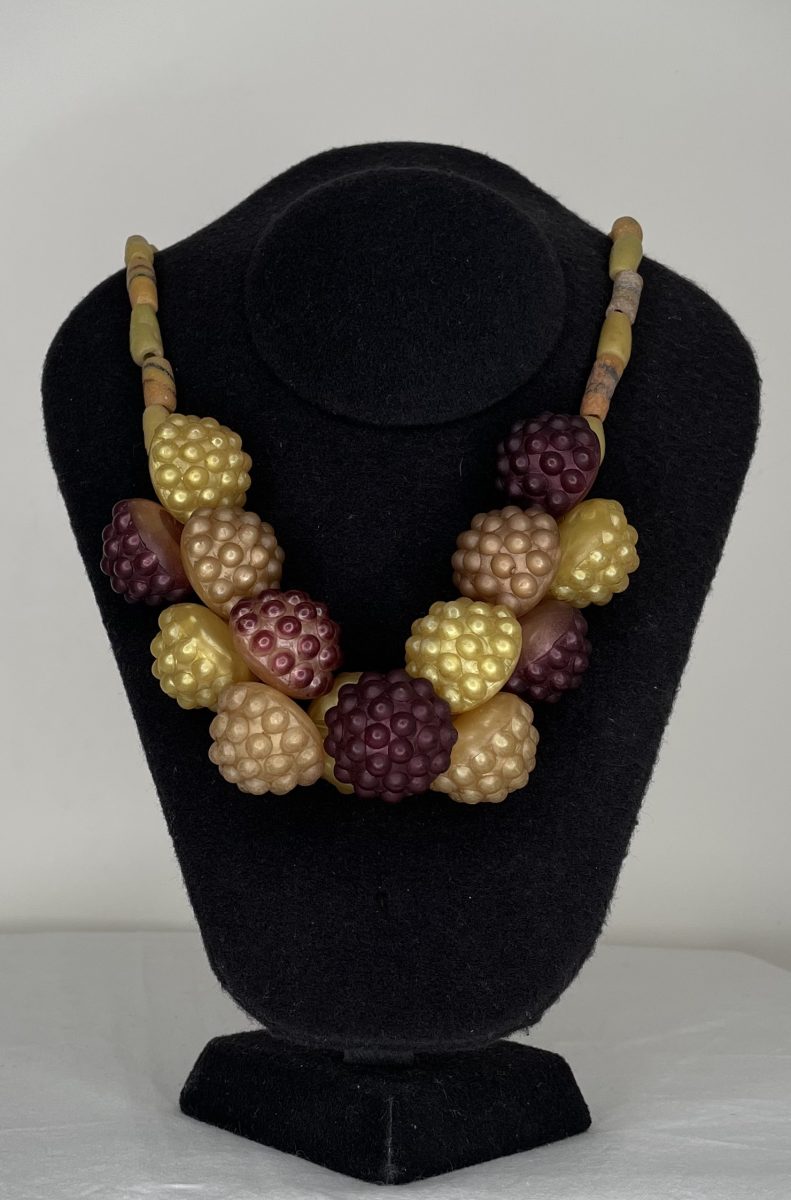 A necklace made from vintage buttons, African trade beads. In the colours of the blackberry' life cycle.