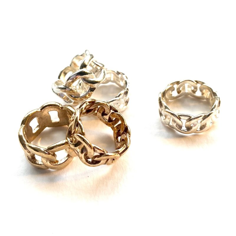 A cluster of hand cast silver and brass rings 