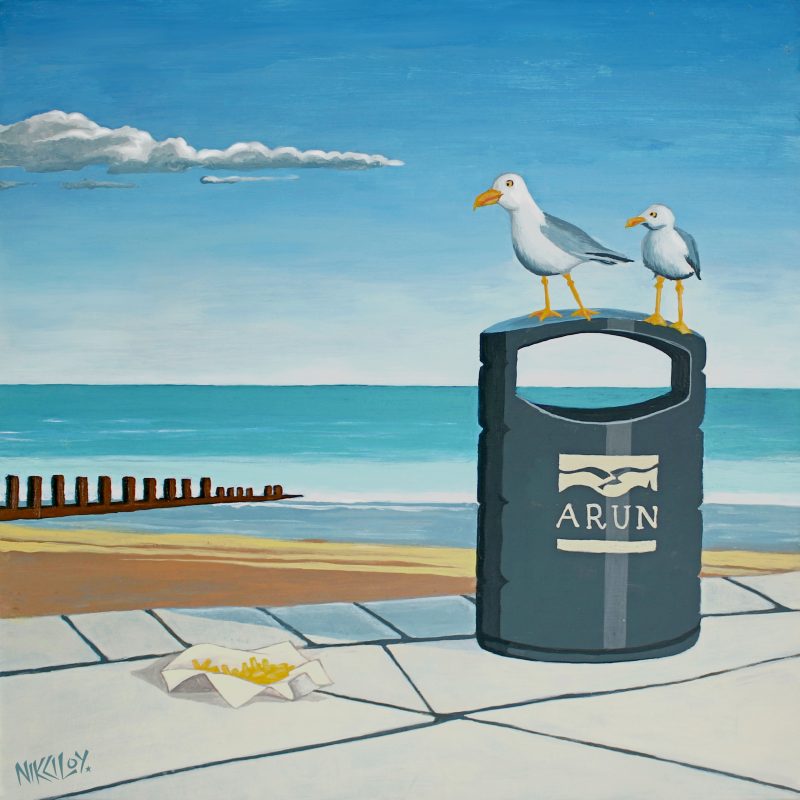 A pair of seagulls sitting on a Arun DC bin on a promenade, in front of a big sky and receding tide... contemplating chips