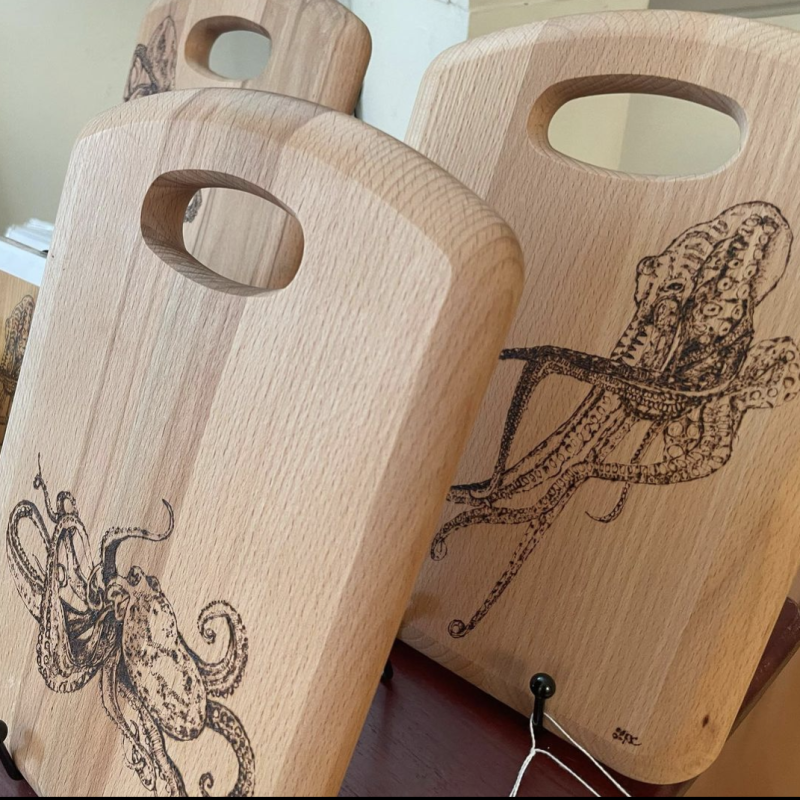 Wooden chopping boards engraved with intricate pyrography drawing of octopus