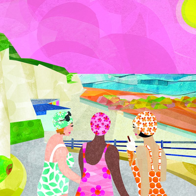 Three ladies in brightly coloured floral swim hats and swim costumes by the sea