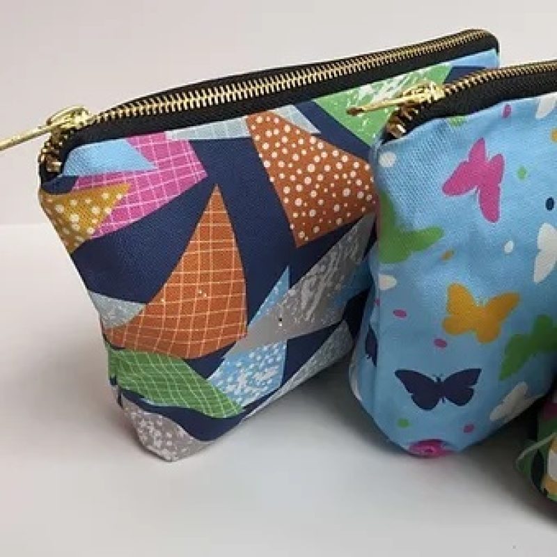 Two make up bags made from Helena Roberts bright patterns, with brass zips.