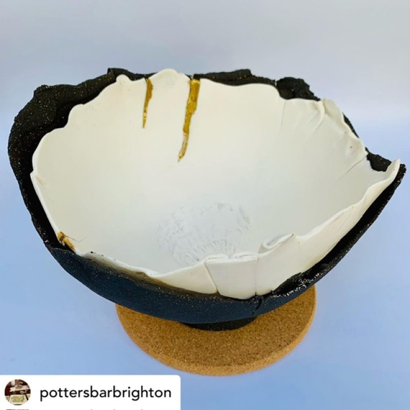 Ceramic bowl. Blue outer shell with white glaze inner nest. 
