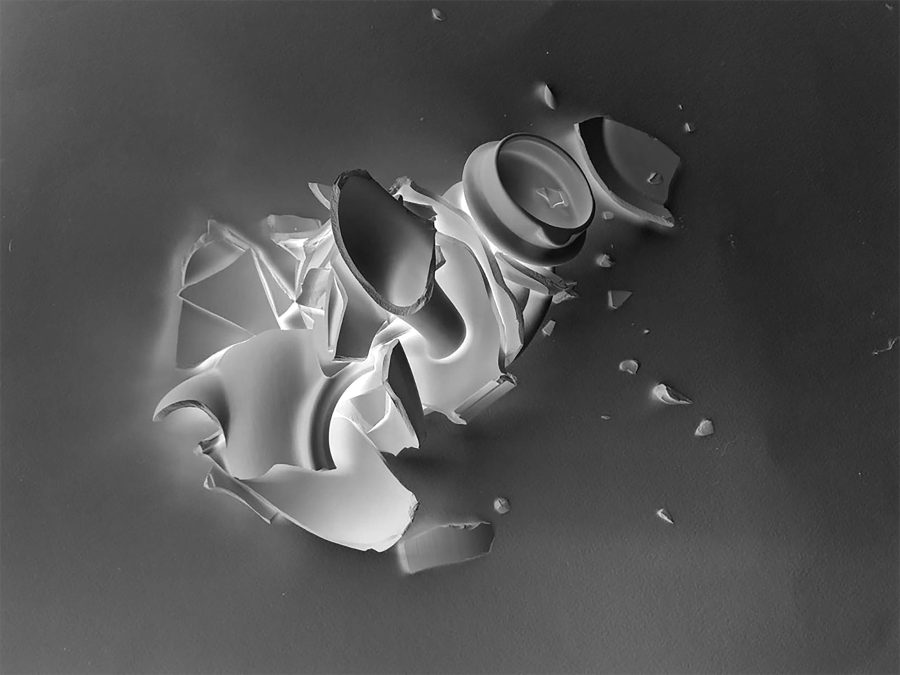 A smashed tea-pot, re-assembled then photographed as an inverted image - from black and white to negative.