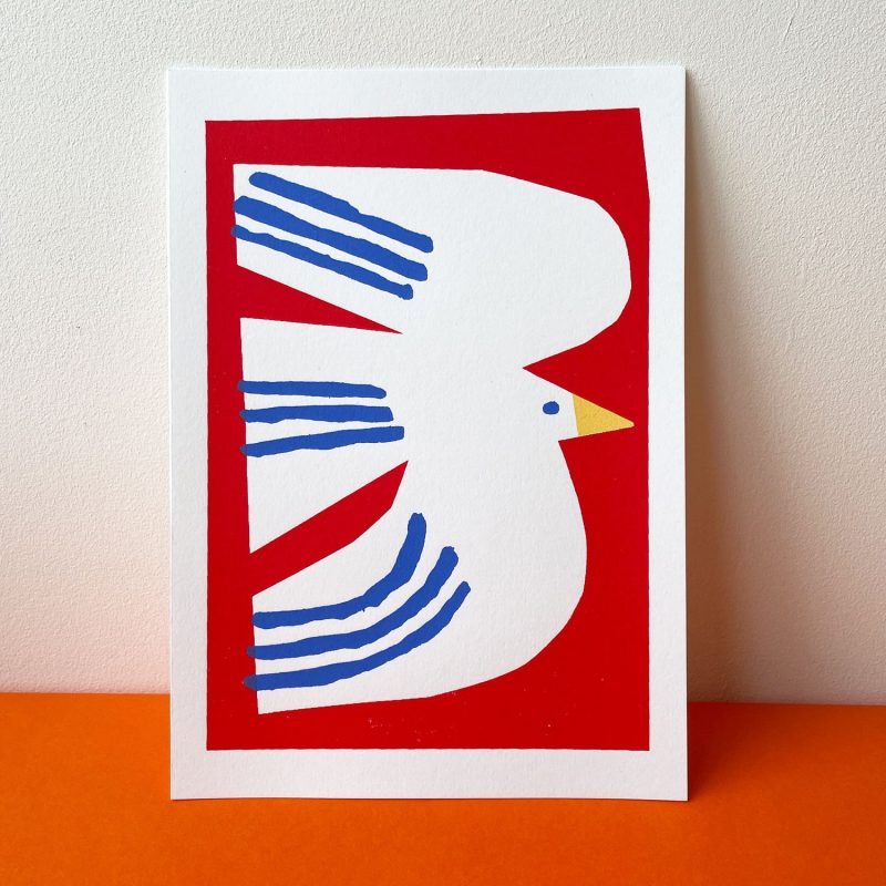 A cut out white bird, on a red background