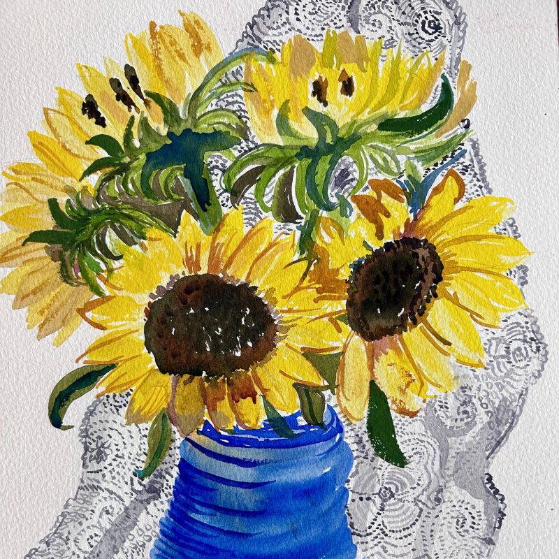 bright sunflowers in a blue vase