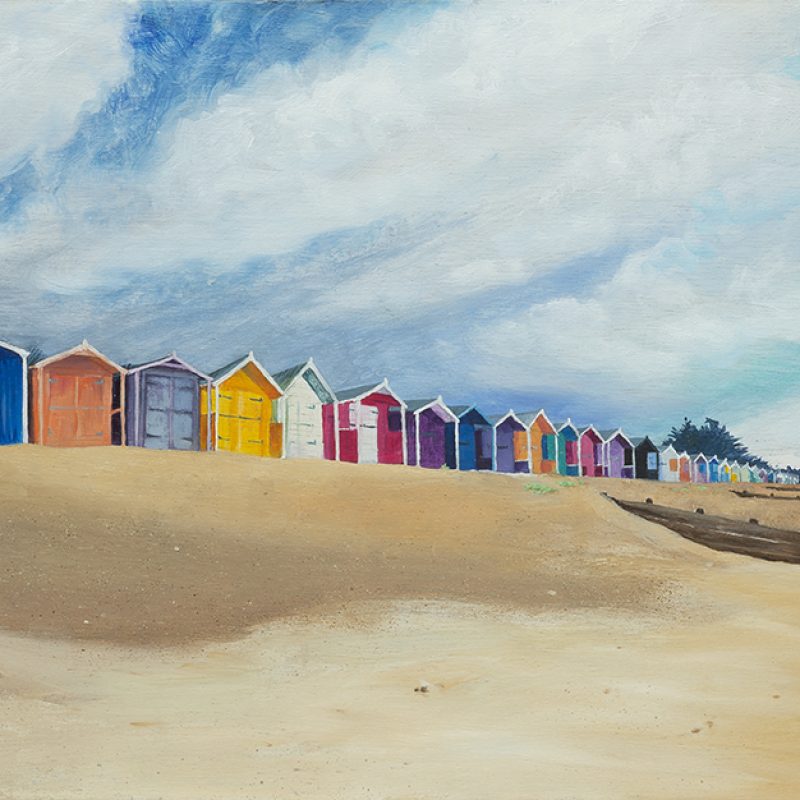 Colourful Panoramic view of Rustington Beach huts with lots of sky and beach.