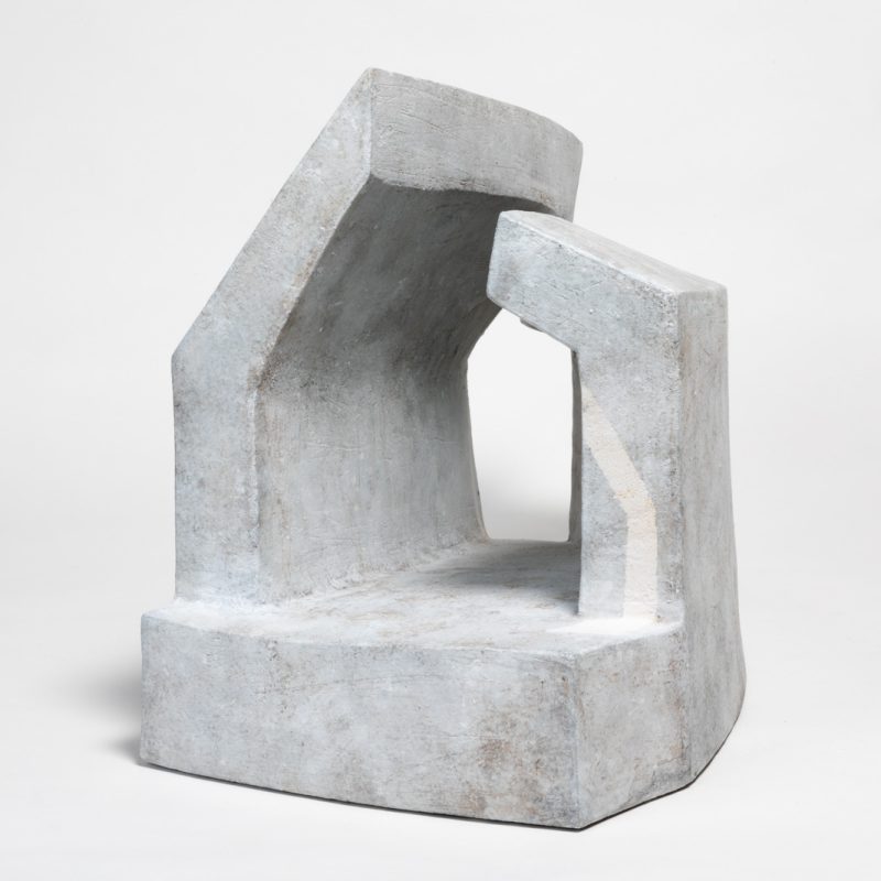 A beautiful minimal ceramic sculpture, pale grey, reminds one of ancient stone monuments or brutalist architecture