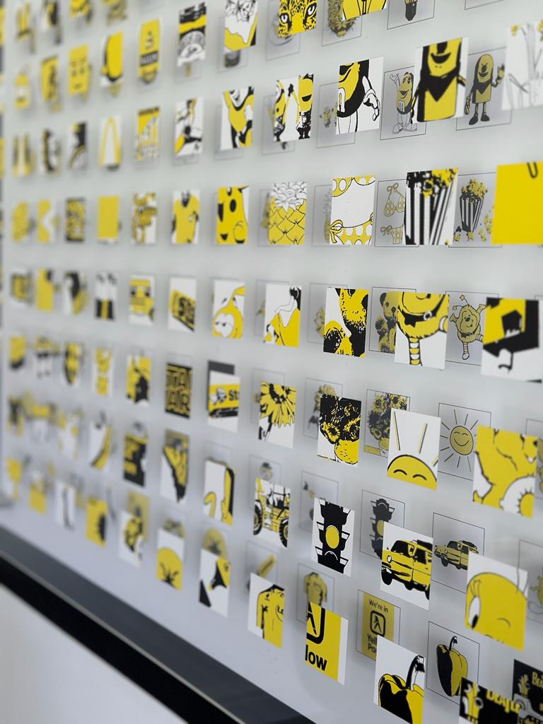 Interactive art ‘Outside the YELLOW Box’ is made up of 169 images of familiar YELLOW items from modern life; film, TV, cartoons or music. Called Outside the Box because each square only reveals part of an image leaving you to guess the answer in full!