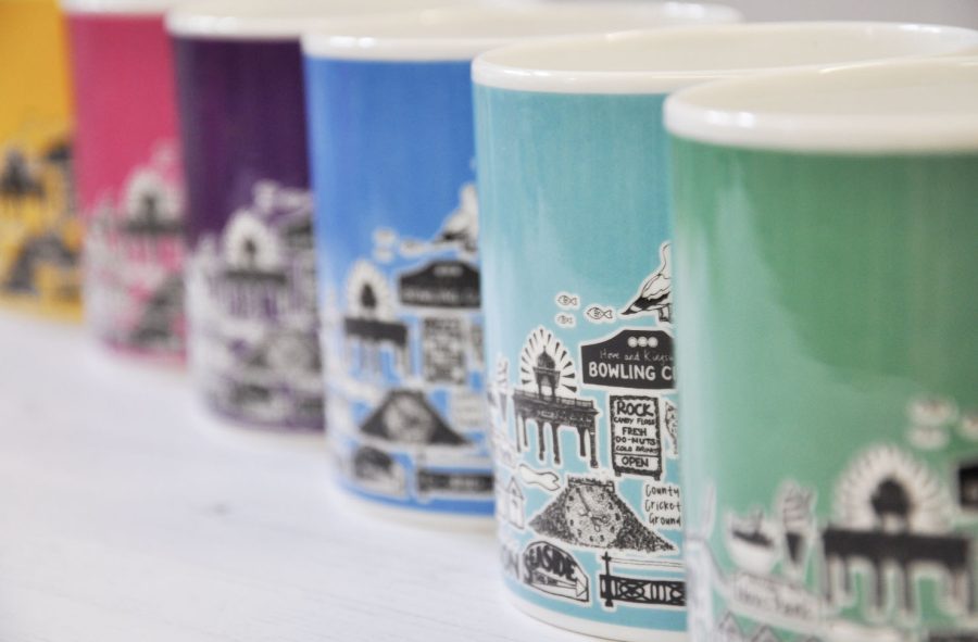 bone china mugs decorated in Brighton colours with a black illustration of iconic Hove imagery.