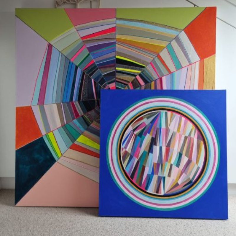 Two brightly coloured painted canvasses with circular patterns