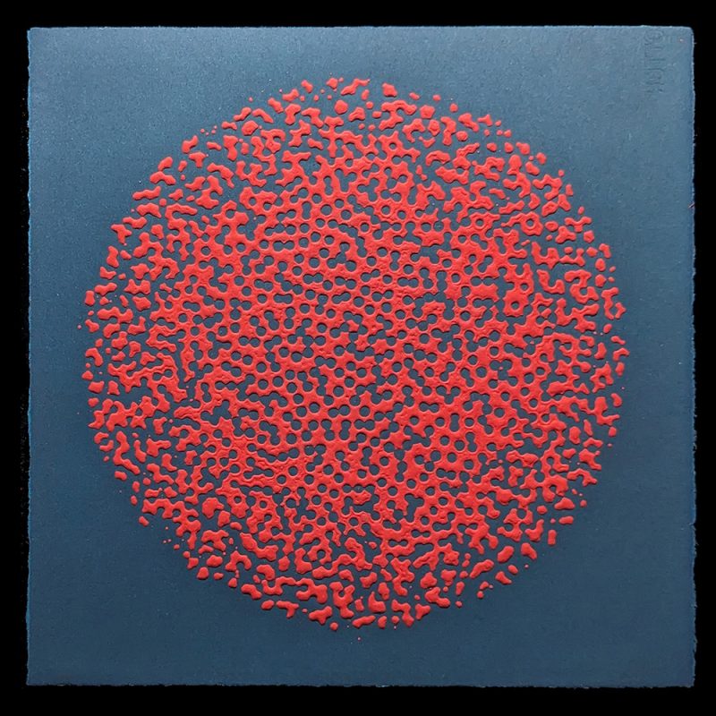 A red circle of random dots on a dark background.
