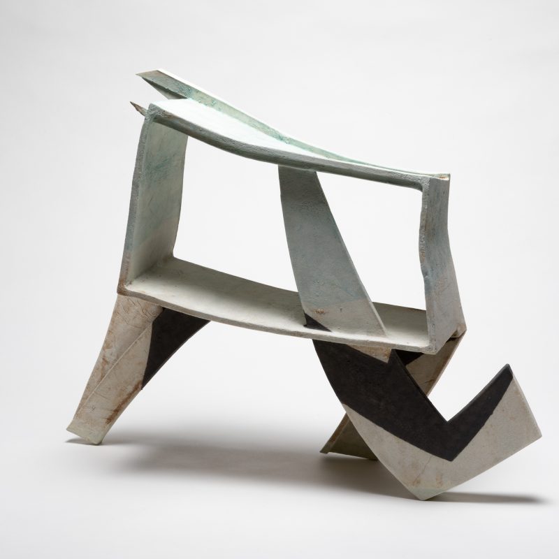 A dymamic abstract sculpture in soft grey,angular and architectural.