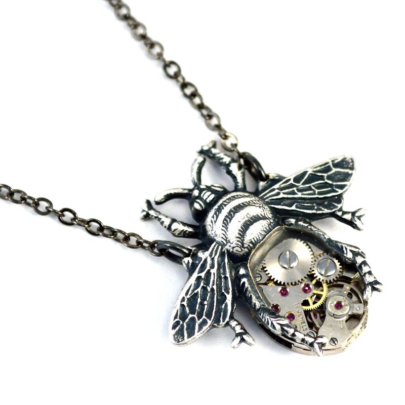 Antiqued silver bee necklace with watch movement belly. 