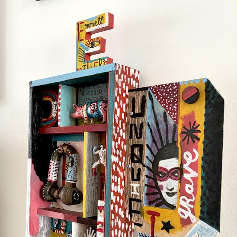 A paint4ed wooden box with collage and found objects