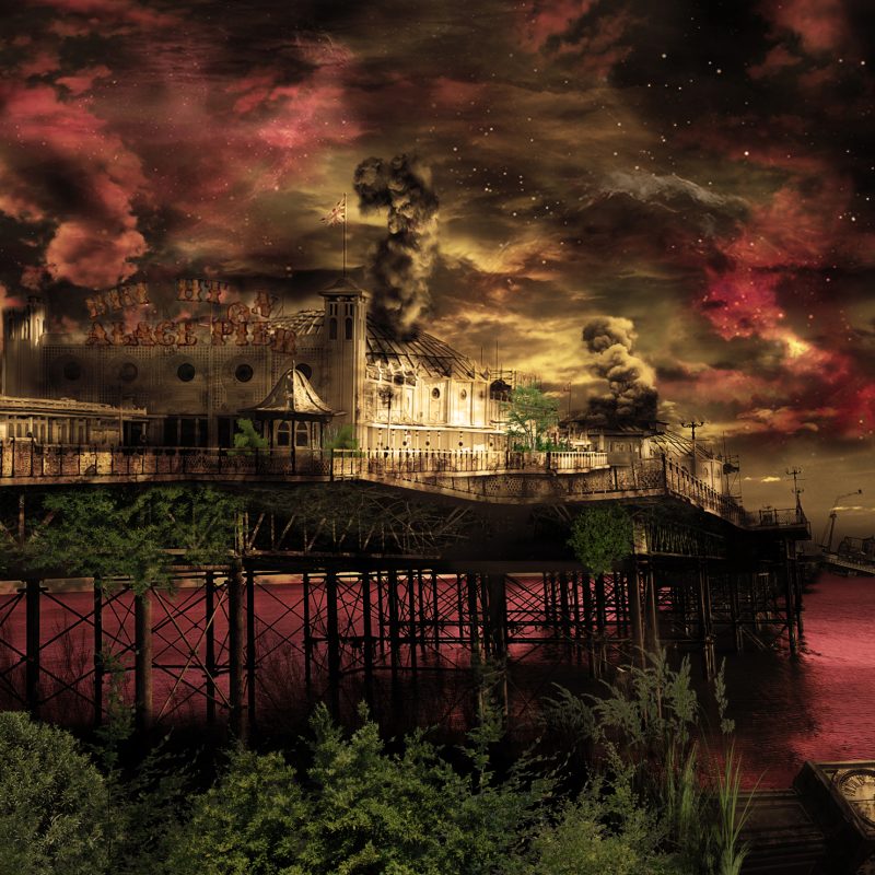 Brighton Palace Pier on fire, fallen clock tower, pavilions in flames, collapsed end of pier.