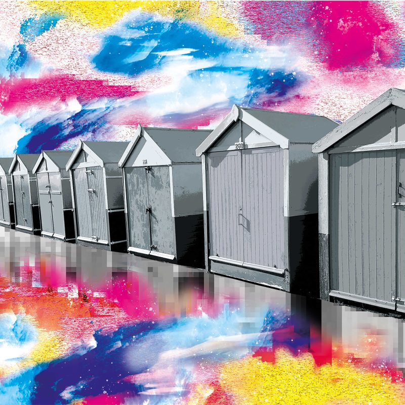 Row of beach huts with grey doors with multicoloured sky and ground