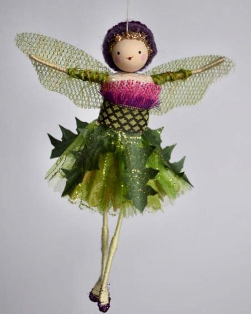 Small textile fairy wearing a green thistle leaf skirt decoration