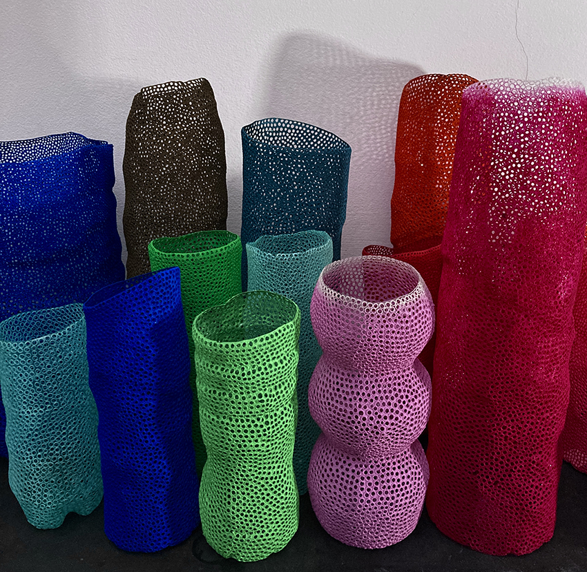 Up-cycled plastic water bottles which have been perforated with hundreds of tiny holes to mimic corals, then coloured