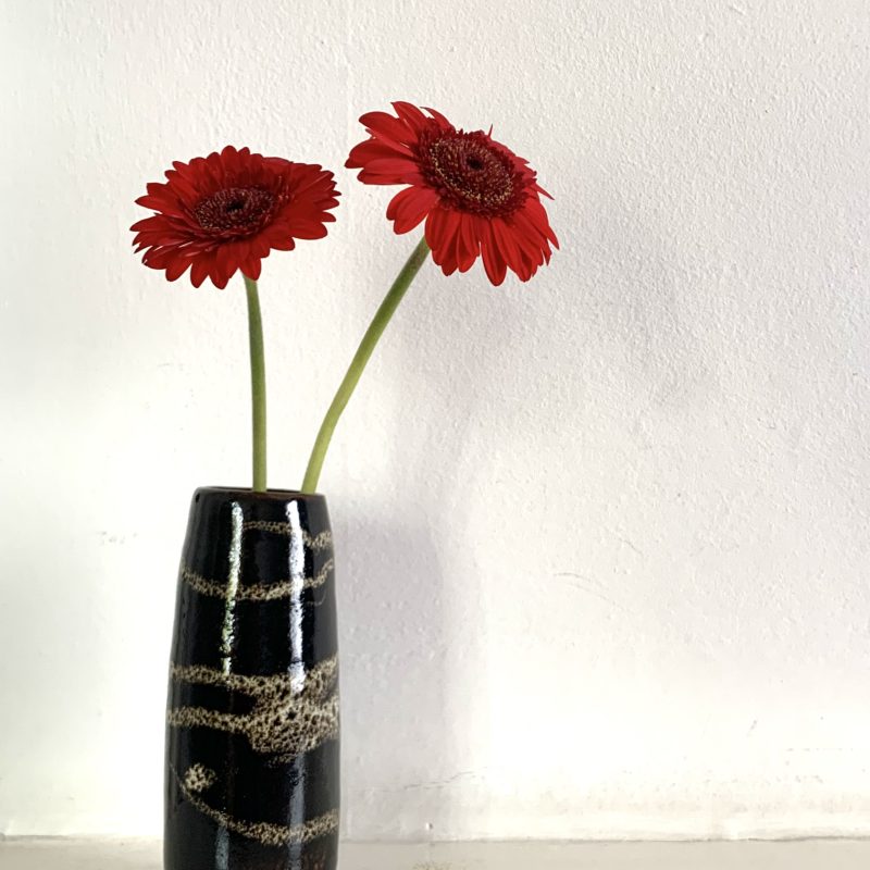 Hand thrown small bud stoneware clay vase, glazed in tammoku (Japanese inspired brown) and white drizzled glaze.