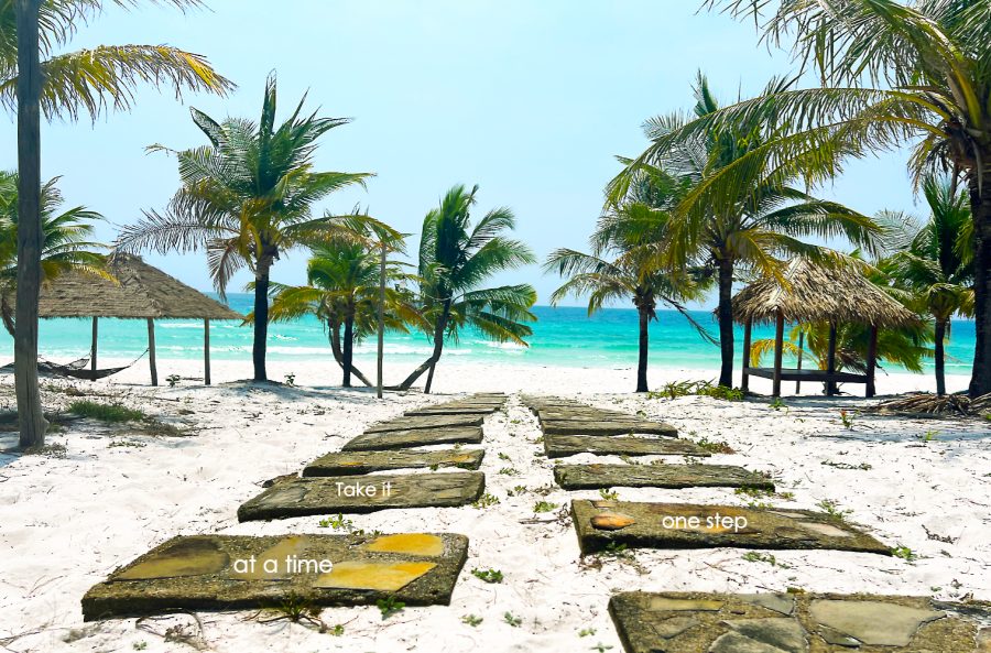 Steps down to a beautiful white sand beach and turquoise sea surrounded by palm trees