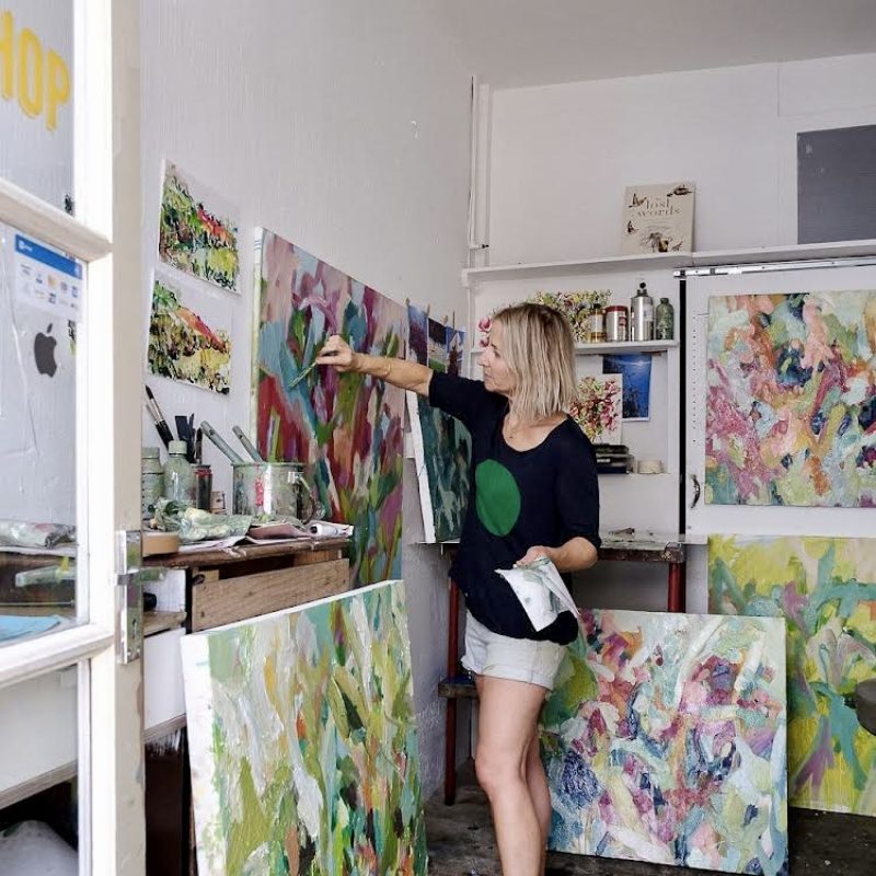 In studio photograph of Clara painting