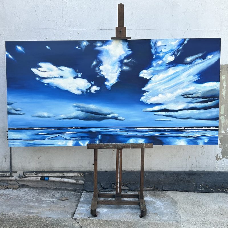 A beautiful blue sky stretched over a high tide and exposed beach. 