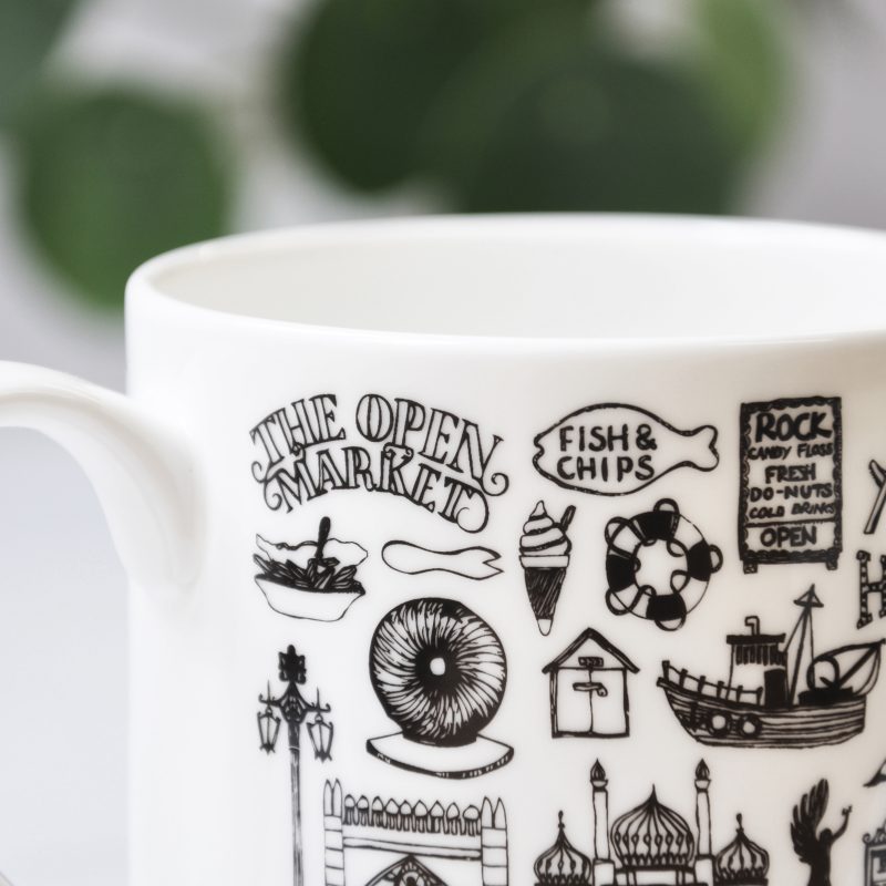 White mug with black graphics of Brighton landmarks