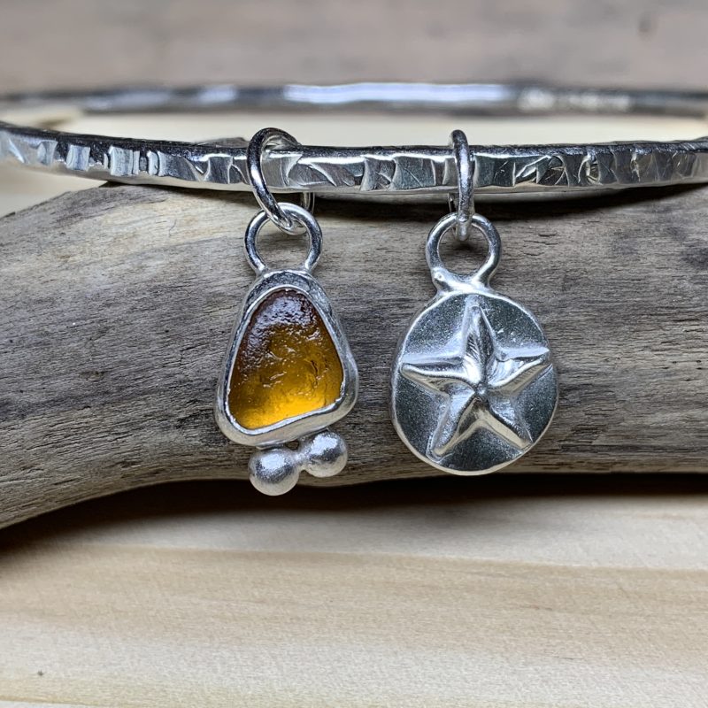 glass and silver star on a bracelet