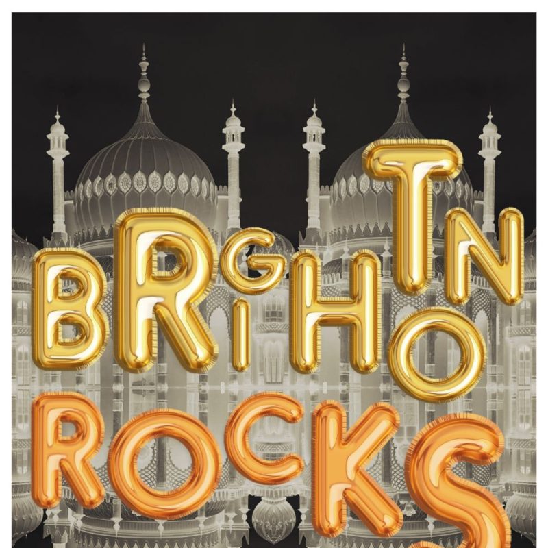 In the background a shimmering Royal Pavilion, Brighton, is reflected forming a mirror image, while in the foreground metallic balloon like letters float, forming the works 'Brighton Rocks'