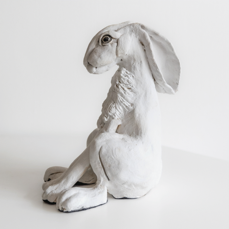 Hand built cermic sculpture of a white snow hare