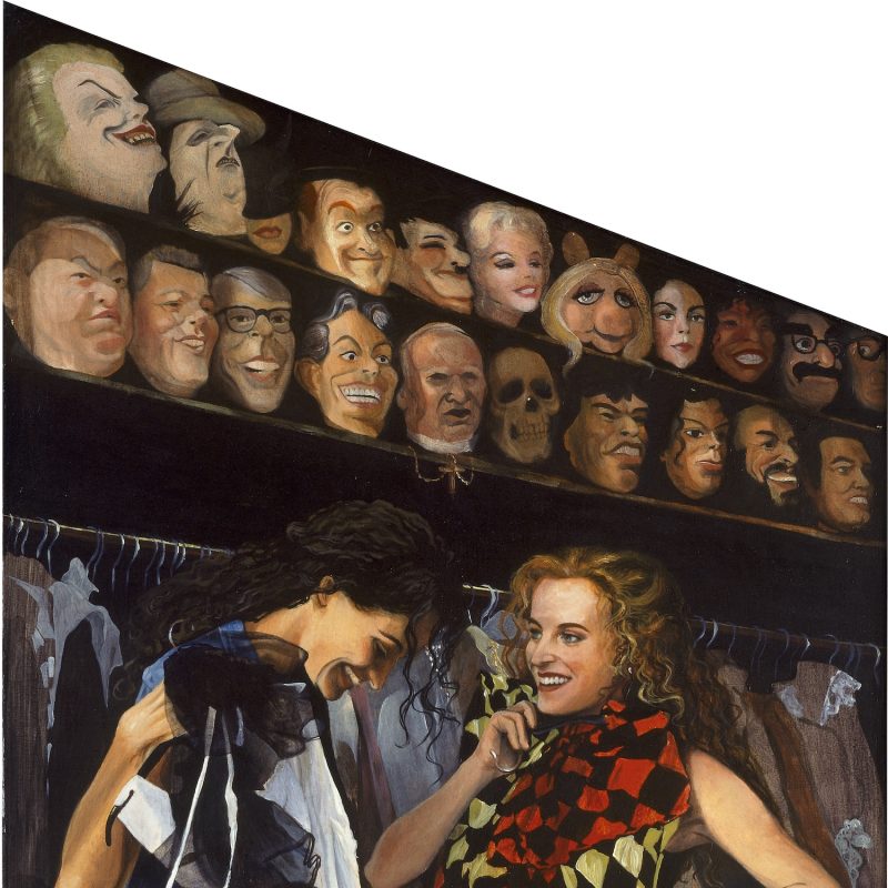 Two young women stand in a fancy dress shop trying on different clothes. on the wall behind them are shelves with masks of politicians and pop stars of the late nineties