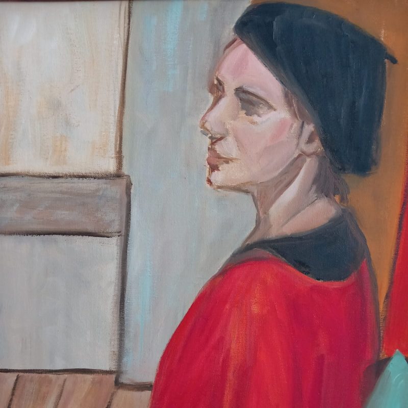 Womad in a red top with a black hat