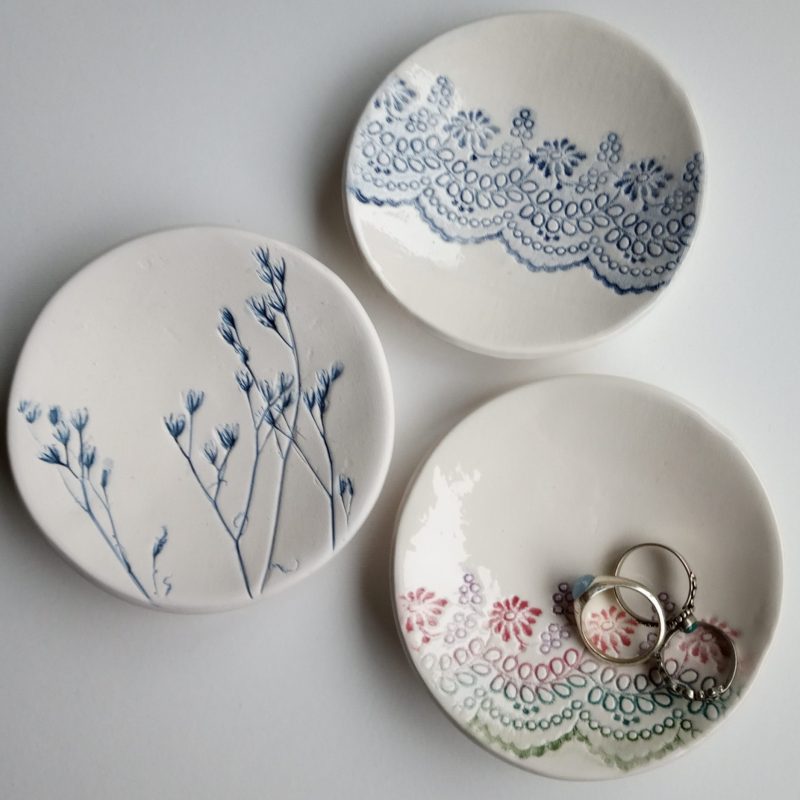 Trinket dishes made from imprinted plants and fabric. Glazed in a deep blue in contrast to the white clay.