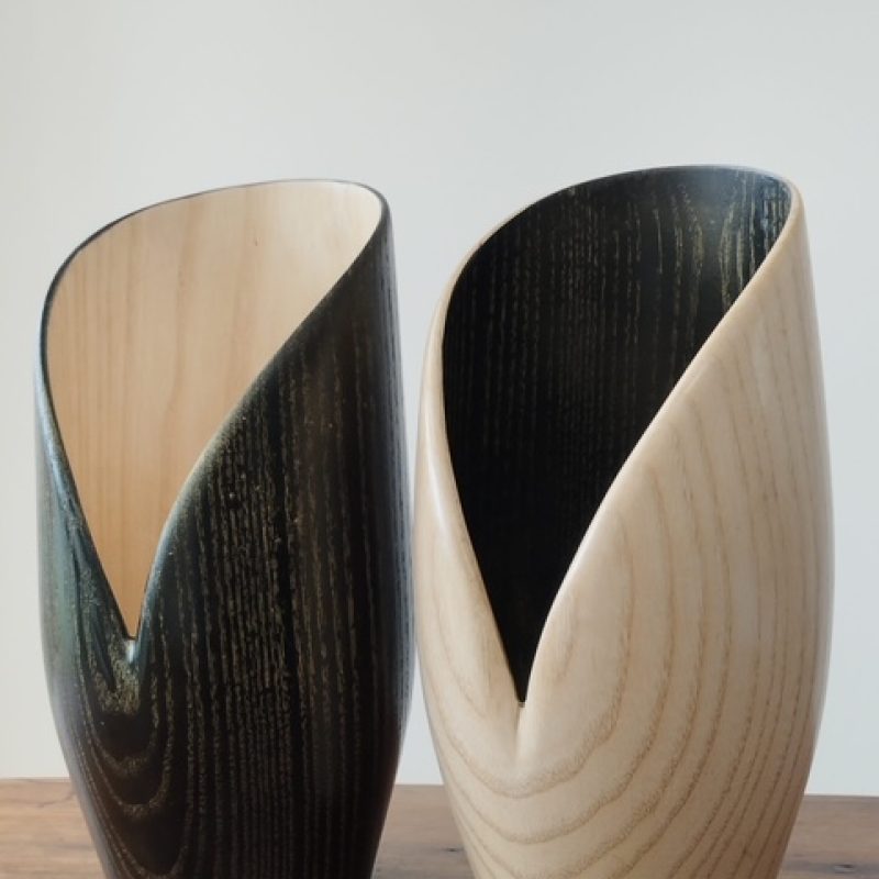 Black and natural coloured wood turned vases