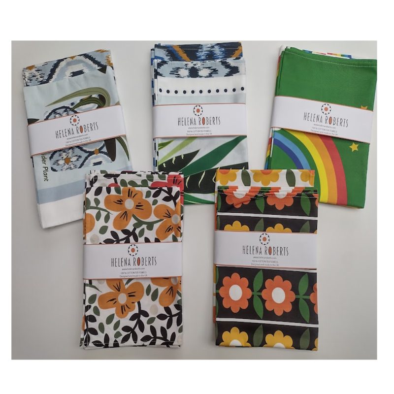 A description of your work for the visually impaired - Colourful, fun, patterned tea towels in bright colours all designed by the textile designer, Helena Roberts.