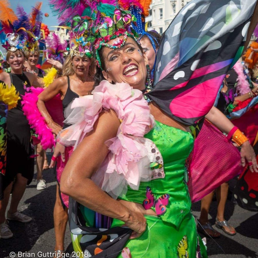 Samba band dressed in feather headdresses and Brazilian costume