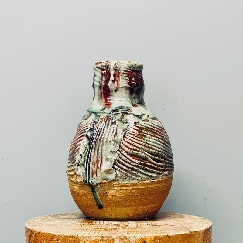 Round vase, glazed with celadon and red copper. 