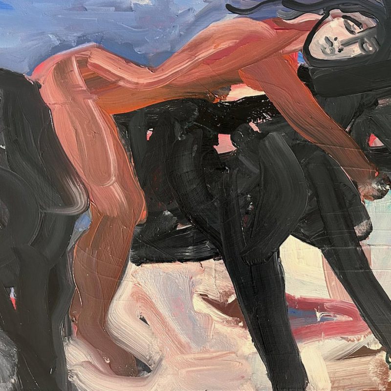 A nude woman lying and holding a black horse.