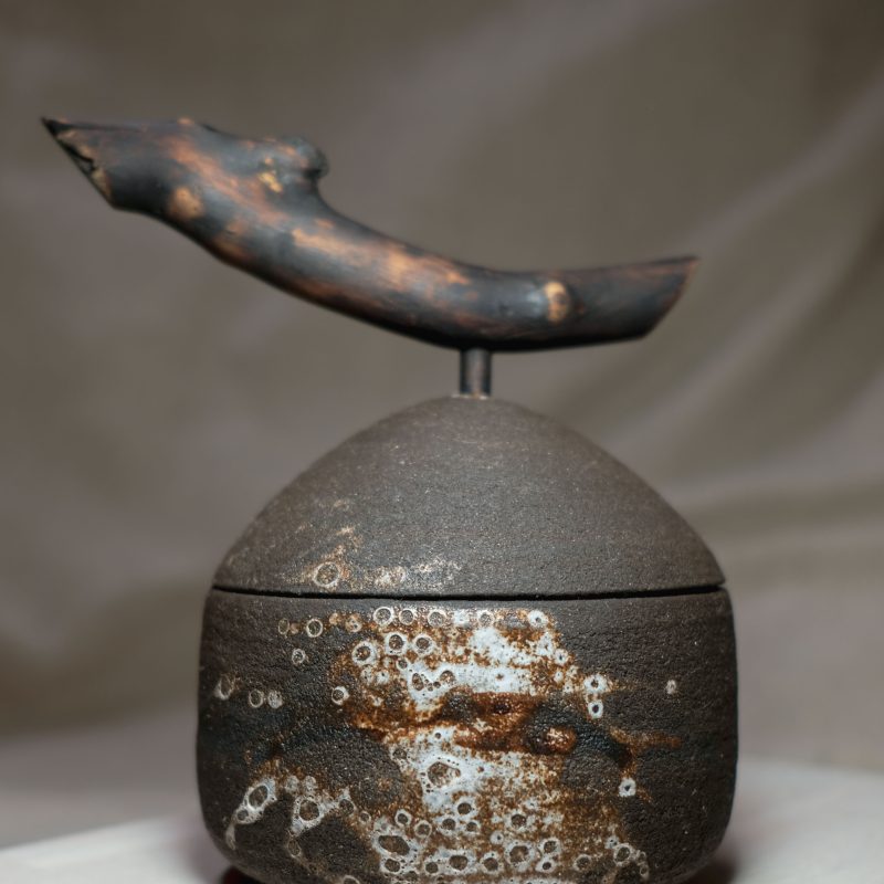 black clay ceramic lidded jar with natural wood handle