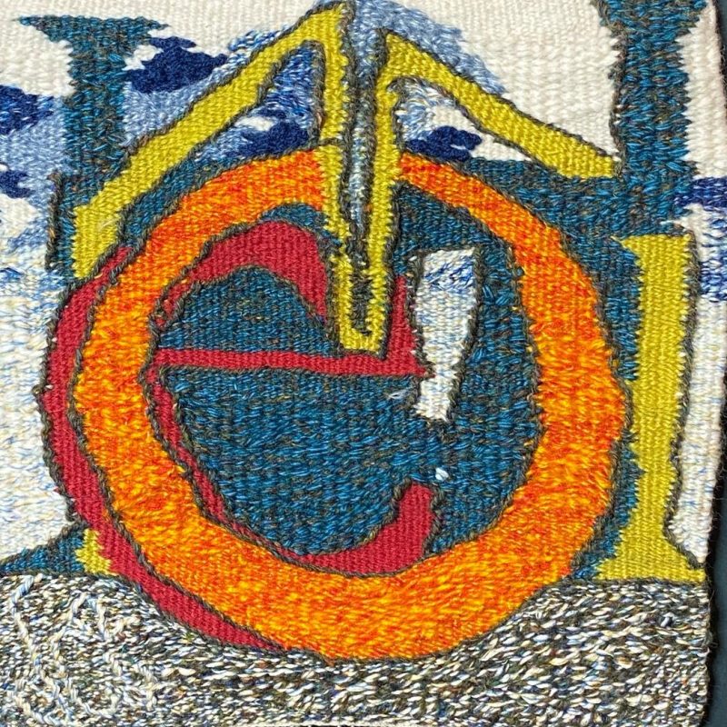 The letters H, O, M, E woven in tapestry to form the shape of a house