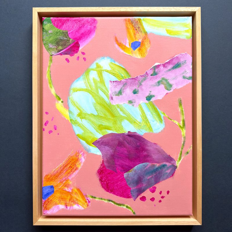 Semi abstracted colourful floral on a light dusky pink background with swirling magenta floral forms and translucent highlights. Rectangular painting framed in natural wood. 
