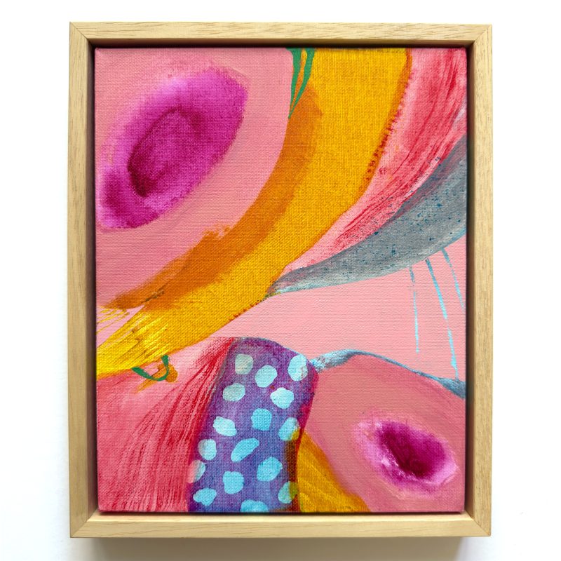 Abstract painting with warm pink and orange hues juxtaposed by subtle violet and grey mark making. Rectangular painting framed in natural wood. 