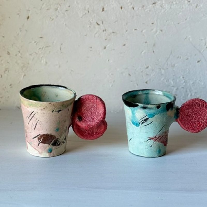 sculptural mug with disc handles in gestural drawing on the body