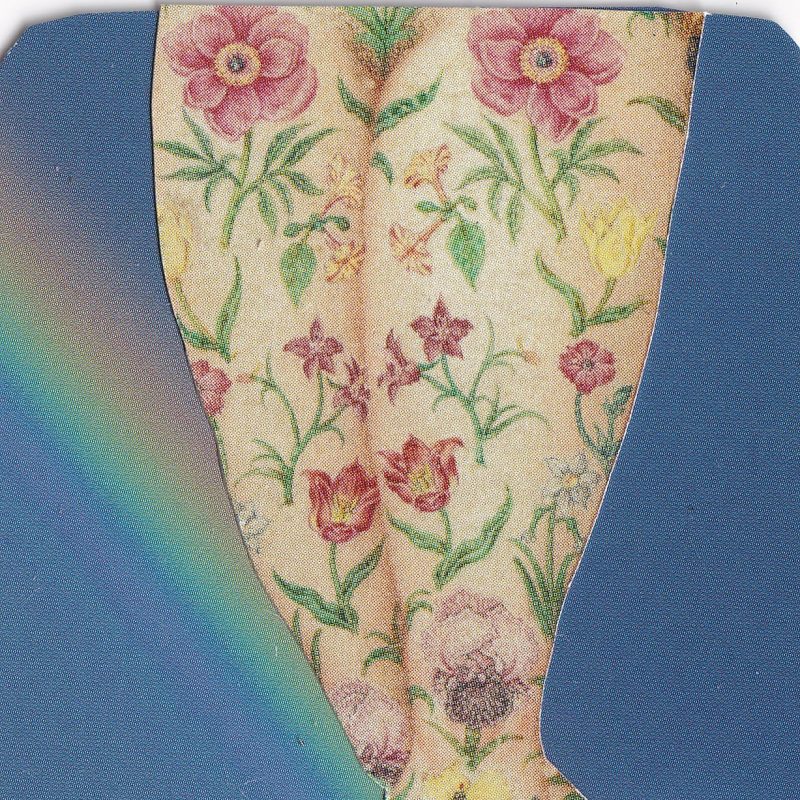 floral tattoed legs of a woman and blue background