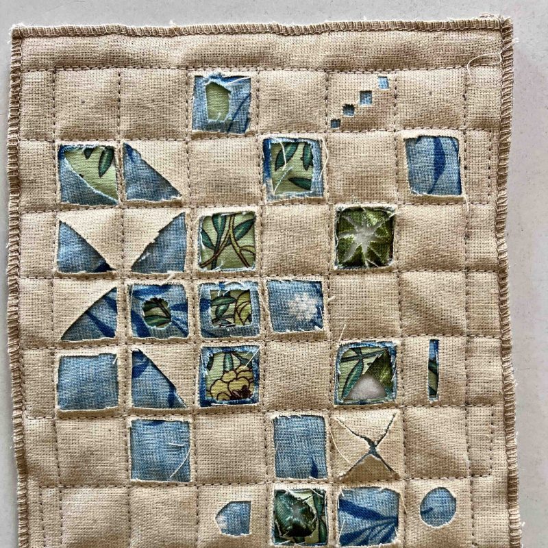 A grid of reversed appliqué squares