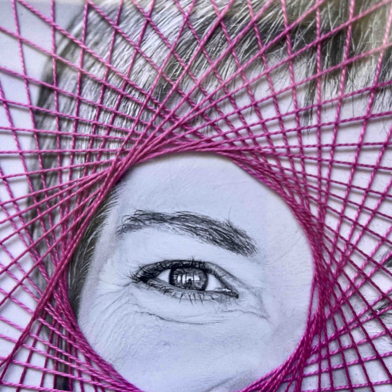 Geometric purple stitching on Black & White photograph of a face